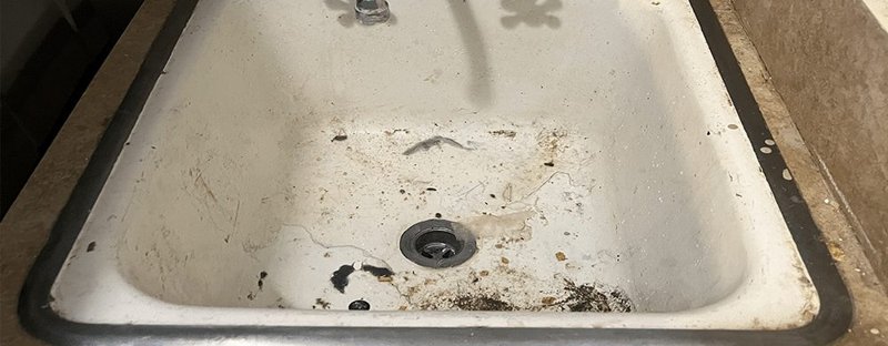 Filthy utility sink before reglazing