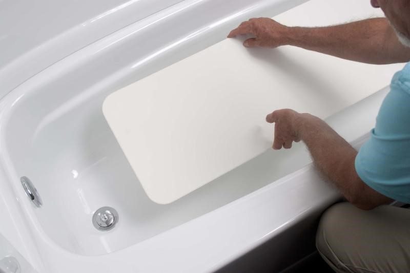 Simply Reglaze technician fitting a precision-manufactured inlay over a repaired bathtub floor