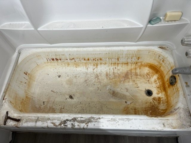 Worn, stained fixture before reglazing